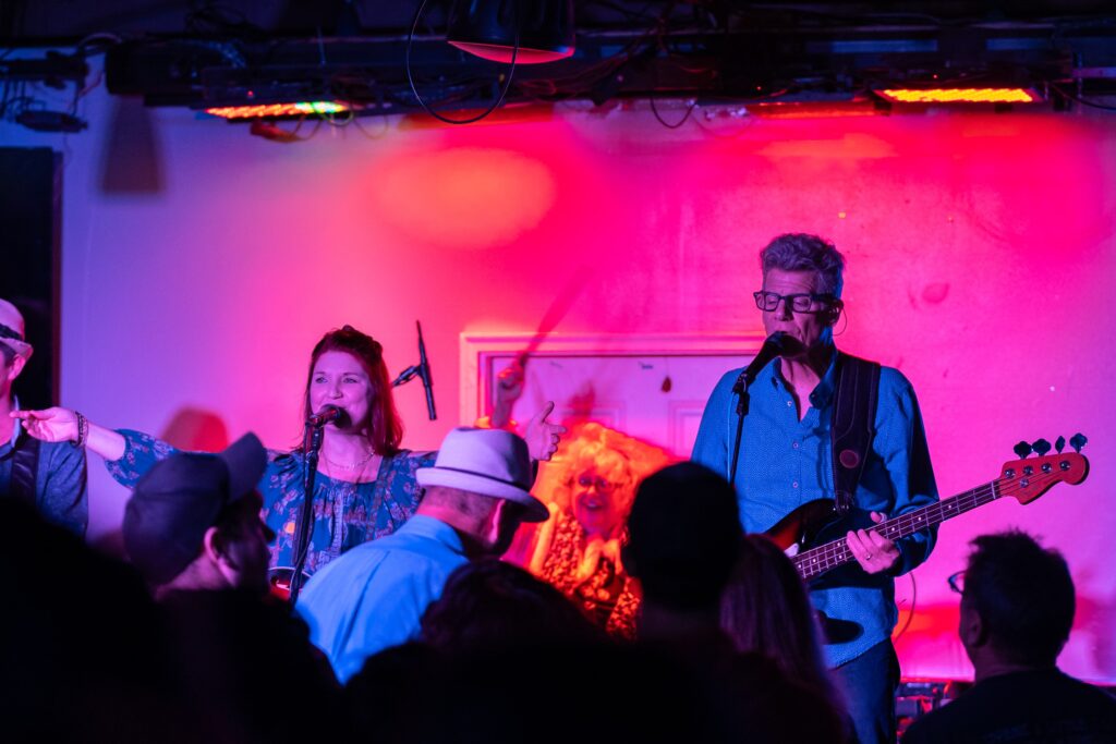 a group of people playing instruments in a room