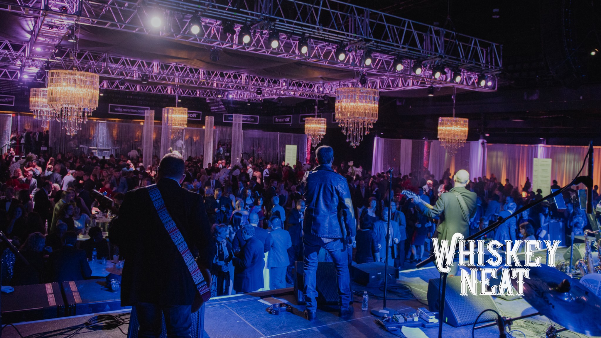 a group of people that are standing in front of a stage