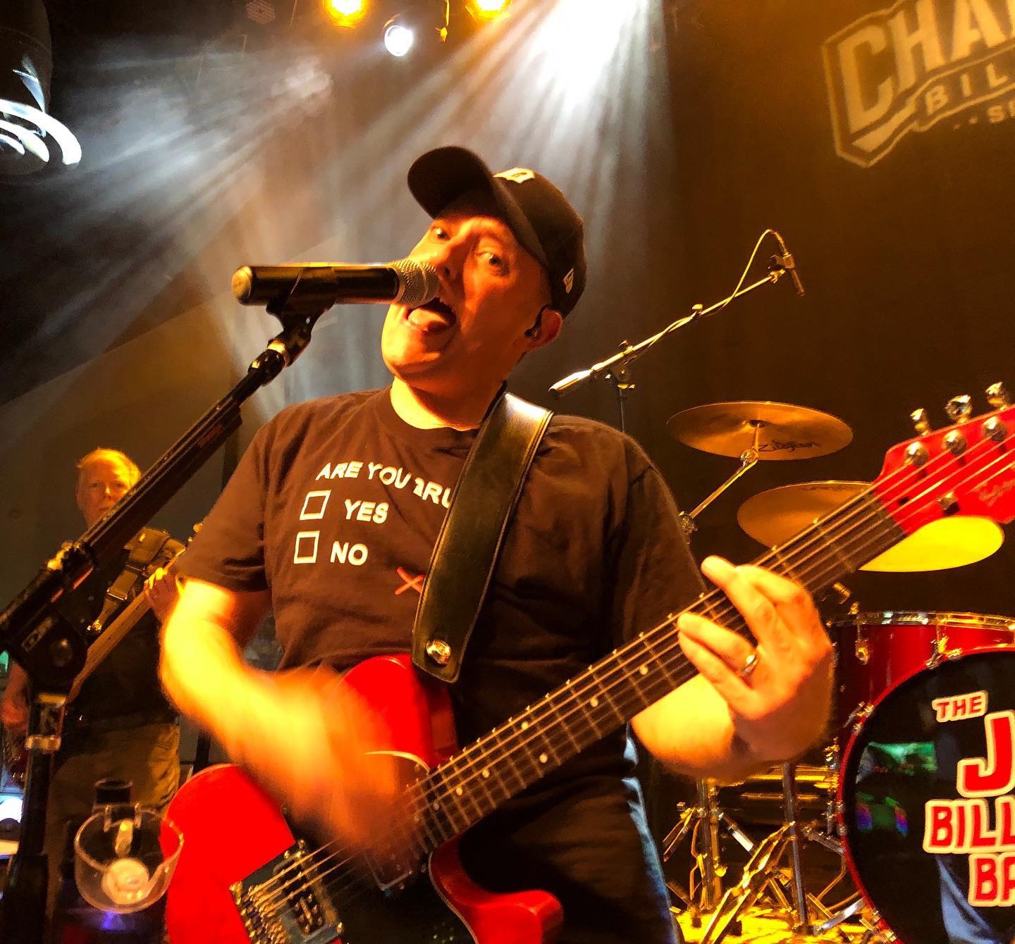 a man with a hat on playing guitar