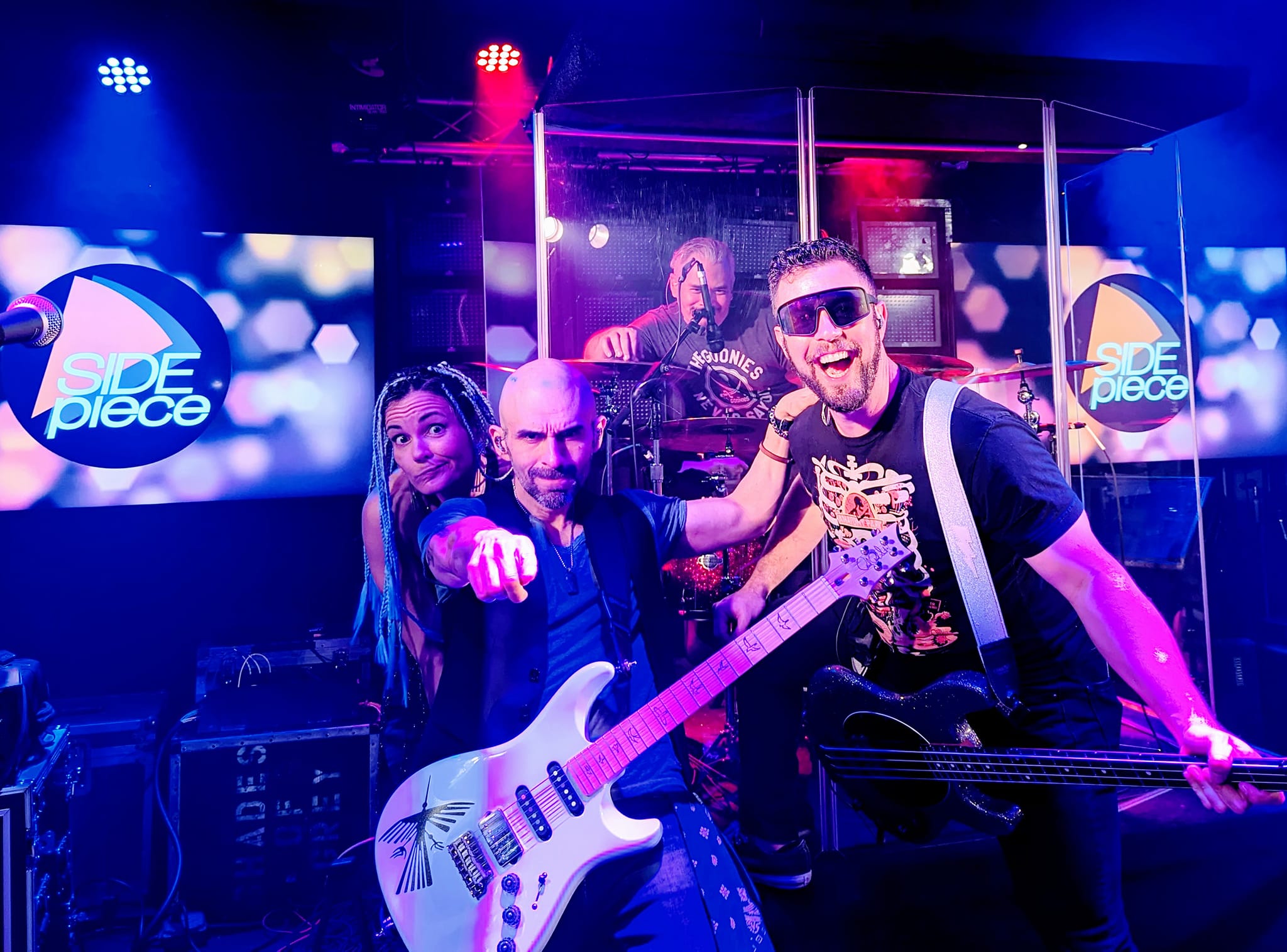 a group of people on stage with guitars