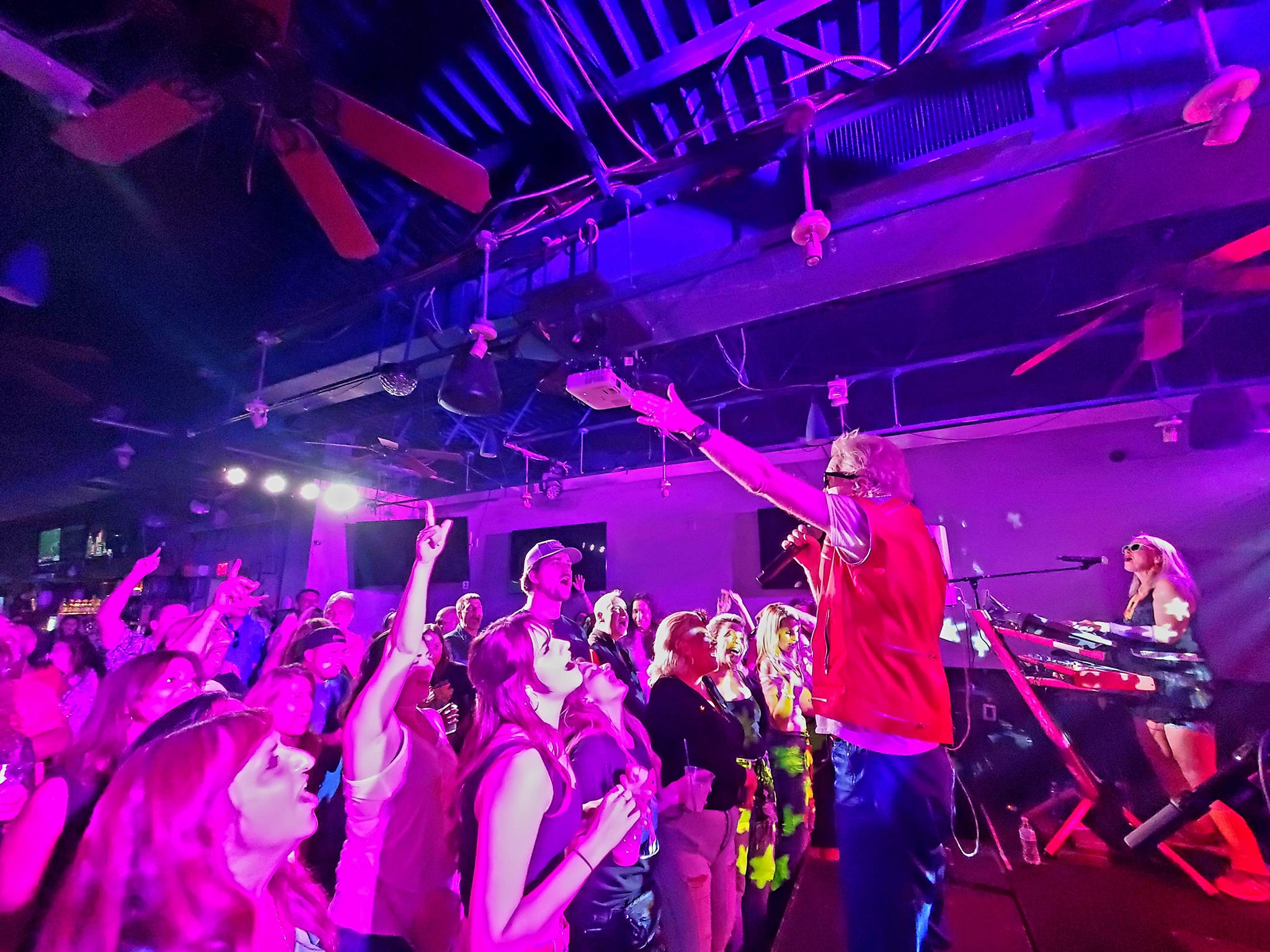 a man standing on top of a stage in front of a crowd