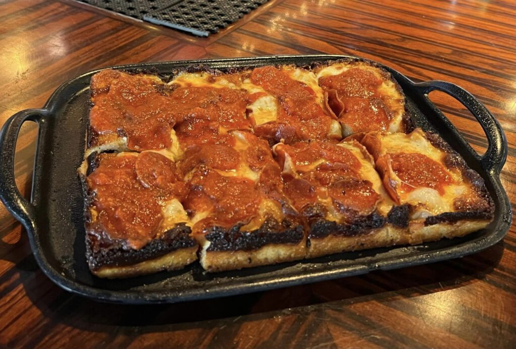 a pan of pizza on a wooden table